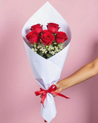 6 red roses and baby's breath. Wrapped in white tissue paper with a thin red ribbon.